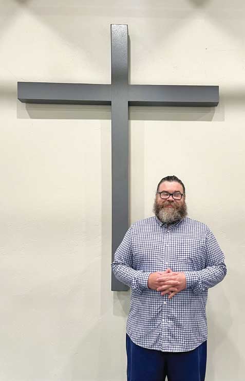Matthew standing by cross