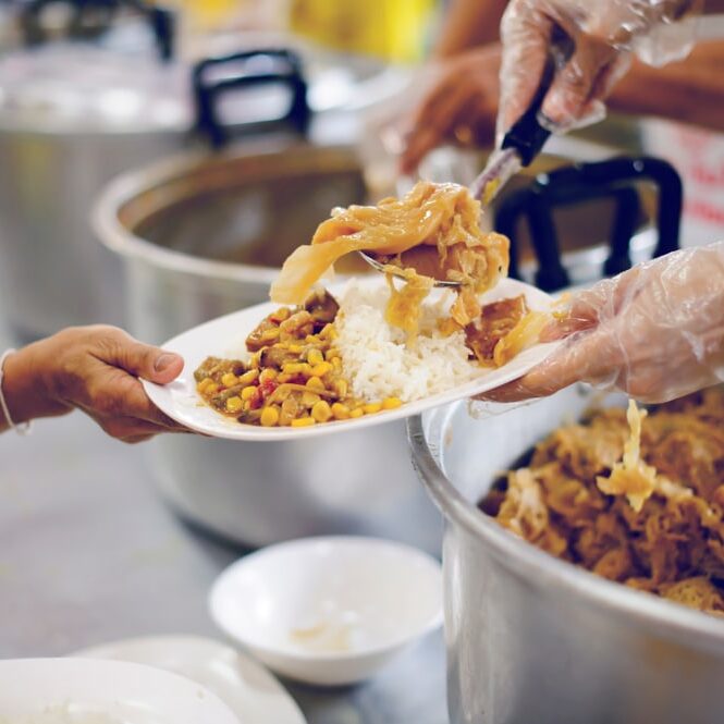 Poor,People,Receive,Donated,Food,From,Donors,,Demonstrate,Mutual,Sharing serving food
