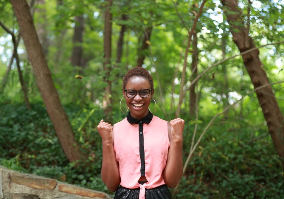 Content,African,American,Woman,In,Eyeglasses,Smiling,Brightly,At,Camera